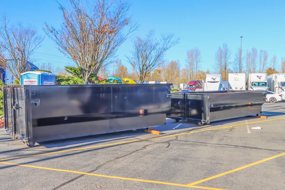 Professional dumpster rental service with roll-off container on residential driveway in Millersville